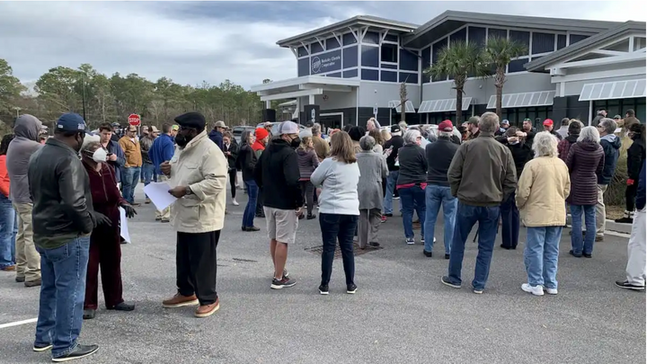 Johns Island residents gather at the Berkeley Electric Cooperative parking lot to voice their opposition to project proposal